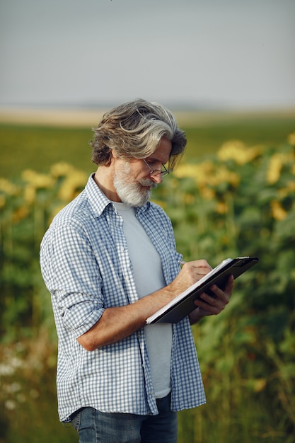 farmer-examines-field-agronomist-farmer-examines-growth-wheat_1157-39764